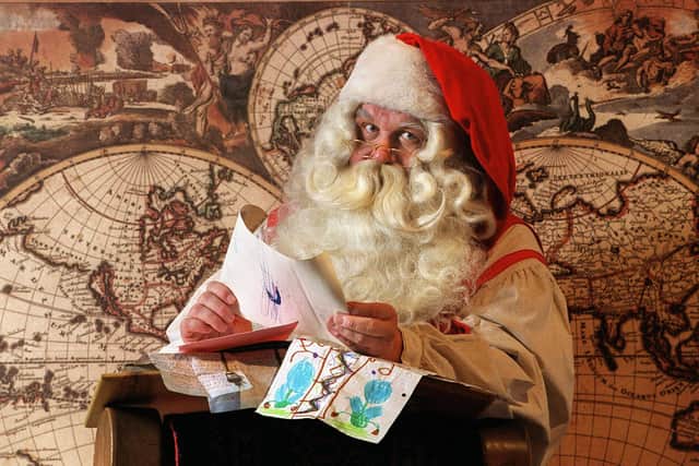 Santa Claus reading letters sent by children   (Photo credit should read MARTTI KAINULAINEN/AFP via Getty Images)