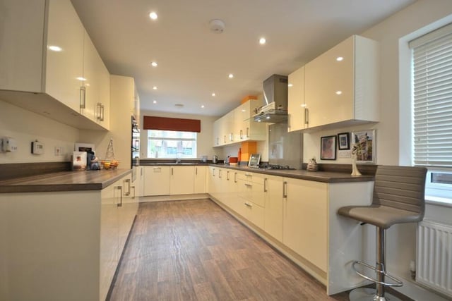 Integrated appliances within the dining kitchen include a five-ring gas hob with matching extractor hood, a fridge/freezer and dishwasher. There is also a one-and-a-half stainless steel sink with drainer and chrome mixer tap.