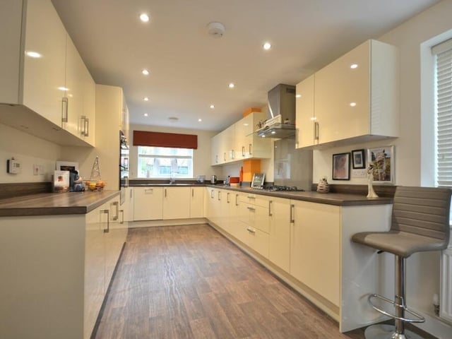 Integrated appliances within the dining kitchen include a five-ring gas hob with matching extractor hood, a fridge/freezer and dishwasher. There is also a one-and-a-half stainless steel sink with drainer and chrome mixer tap.