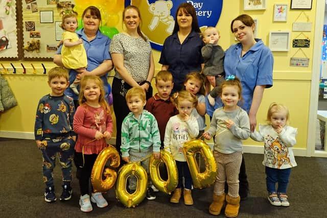Staff and children celebrate Paper Moon Day Nursery's good Ofsted rating.