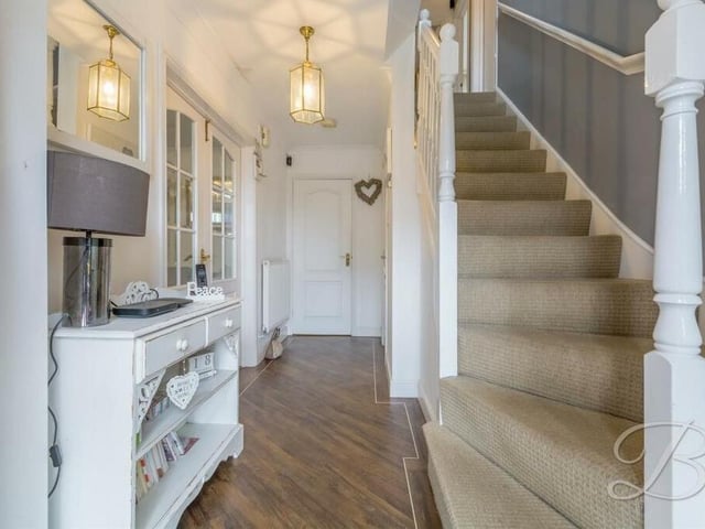 As we prepare to go upstairs, let's pass through the lengthy and welcoming entrance hallway.