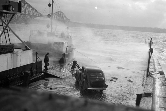 Cars boarding the ferry for the crossing of the Forth from South Queensferry during storms in January 1953.