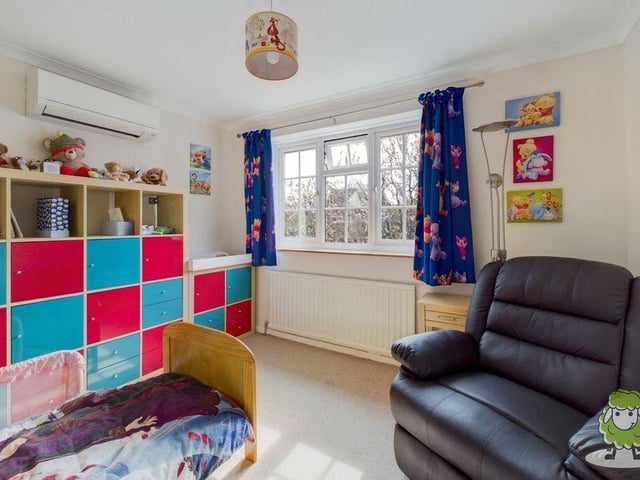 Bedroom number three at the £995,000 property is currently set up as a bright and breezy child's room. It offers garden views.