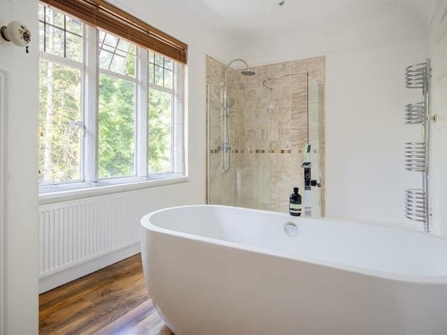 This Jack and Jill bathroom, which can be accessed directly from the main bedroom, features a free-standing bath, enclosed shower and heated towel-rail.