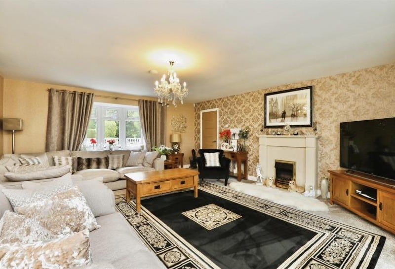 How about this for cosiness and comfort? A bright and relaxing lounge with feature fireplace.
