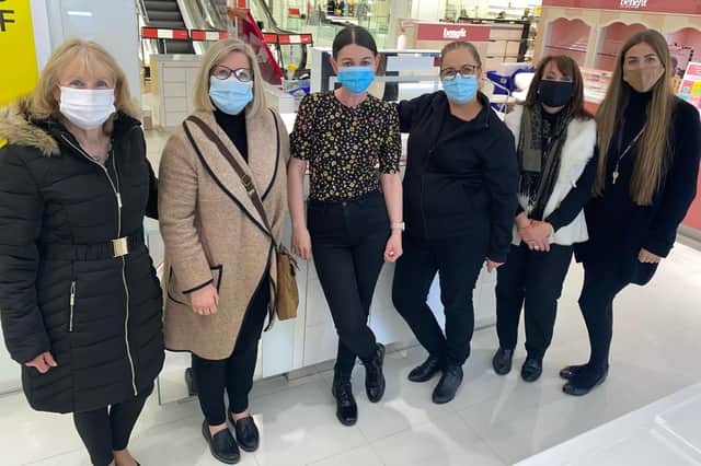 Long-serving employees Julie Howe (second right) and Glenis Thompson (second left) with other members of the cosmetics team at Mansfield's Debenhams store.