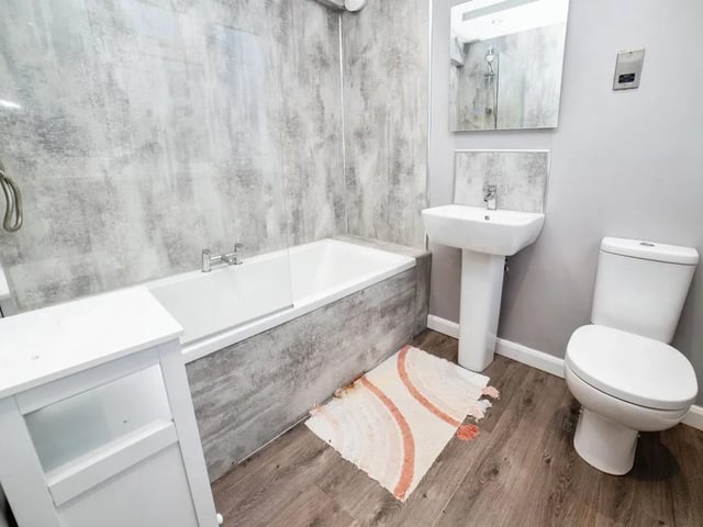 Featuring a shower over the bath, toilet and sink.