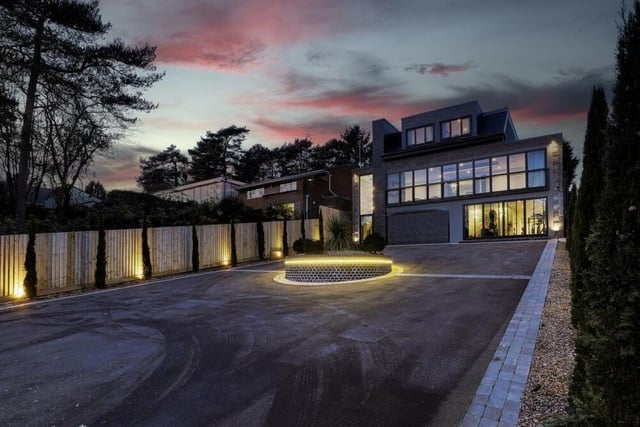 The modern house looks just as appealing when lit up at night as during the day.
