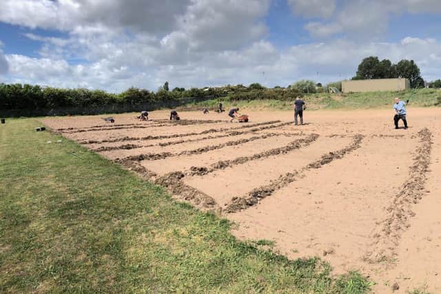 Volunteers map out a new training pitch at Clipstone, which will be floodlit.
