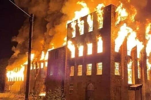 Fire rages at the Hermitage Mill building after the arson attack of March, 2022.