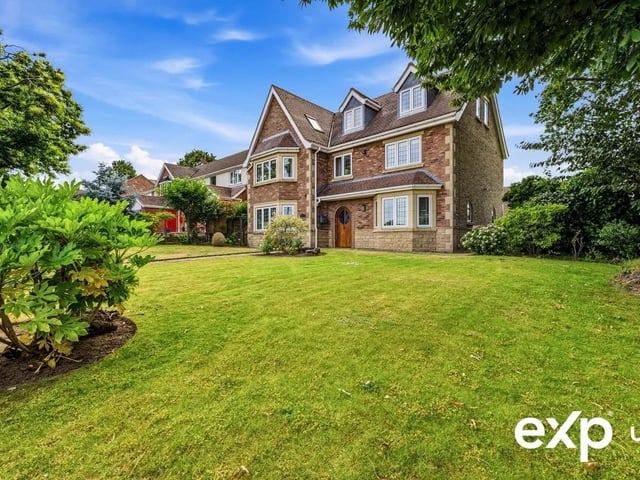 To the front of the property is a neat hedge boundary, where a pedestrian gate opens onto a pathway leading to the house that sits back in the attractive front lawn with its established shrub and tree-lined borders.