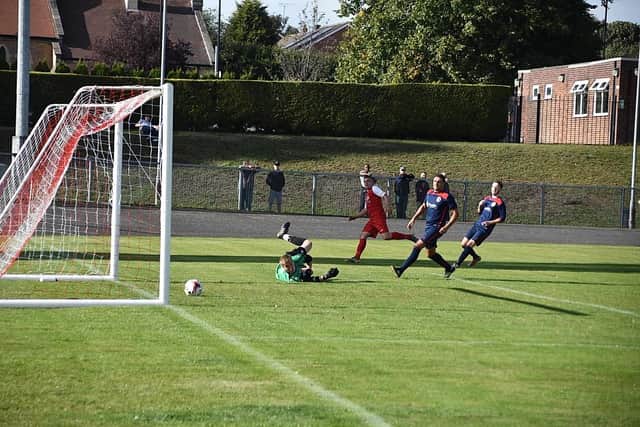 Ross Duggan slots home the leveller in AFC’s 3-2 FA Vase win over local rivals Rainworth.