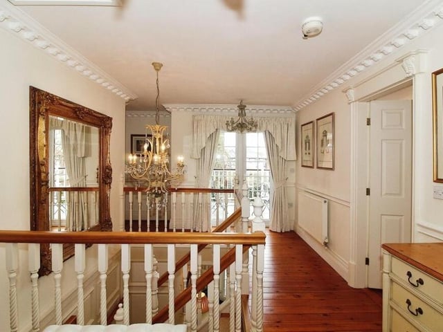 Our whistle-stop tour of the Sutton property takes us upstairs now, and to this immaculate landing that guides us to all five bedrooms.