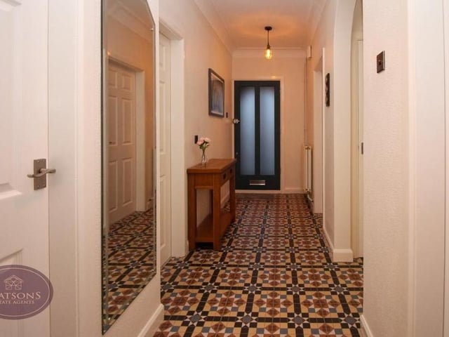 The long and narrow entrance hallway guides you to all the main rooms at the £325,000 bungalow.