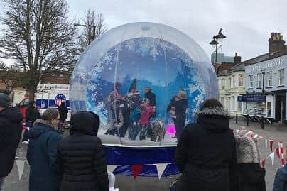 Shoppers marvel at a giant, inflatable snow globe that is set to tour the Mansfield area this Christmas.