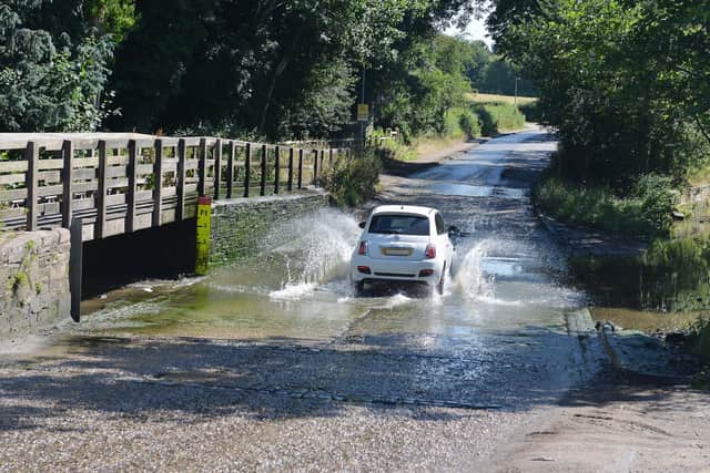 DECEMBER -- the Rufford Mill Ford was closed to motorists after it became an unlikely tourist attraction with drivers splashing through the water in front of large crowds.