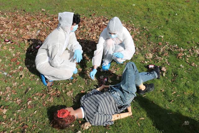 Students applied their classroom theory of forensics to the mock crime scene