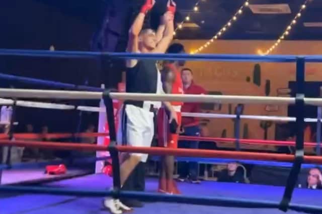Freddie having his hand raised as victor defeating Dwyer.