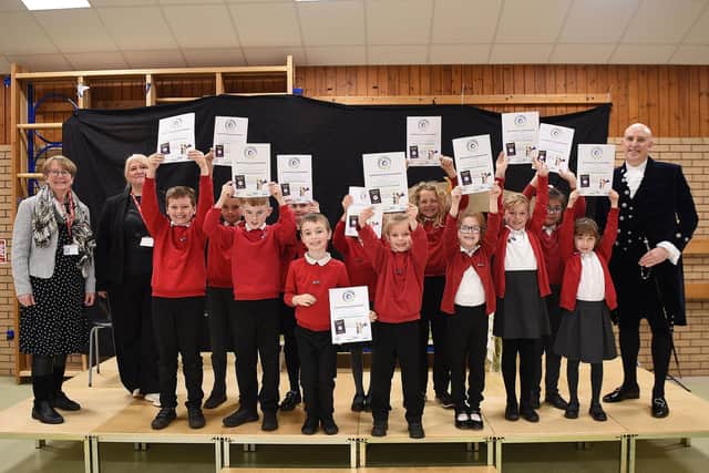Maddy Pritchard (Vibrant Warsop) far left, Jo Yardley (Head of Church Vale School) second left  and Nick Rubins (High Sherrif of Nottingham) right. Pupils of Church Vale Primary School holding their Feeling Great Passport Ambassador certificates centre.