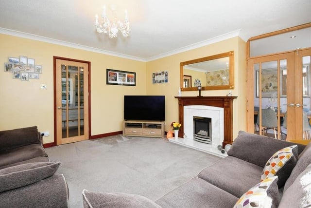 Our photo gallery of the Huthwaite bungalow begins in this smashing lounge, which has a gas fire with attractive surround, carpeted floor and French doors leading to the kitchen/dining area.