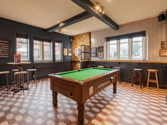 The pub has regulation dart boards and pool tables