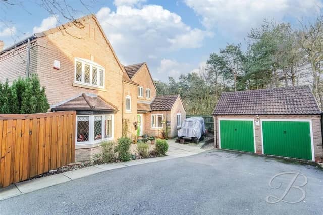 At the front of the property, a large driveway offers ample off-road parking for multiple cars plus a double garage providing space for vehicles and additional storage.