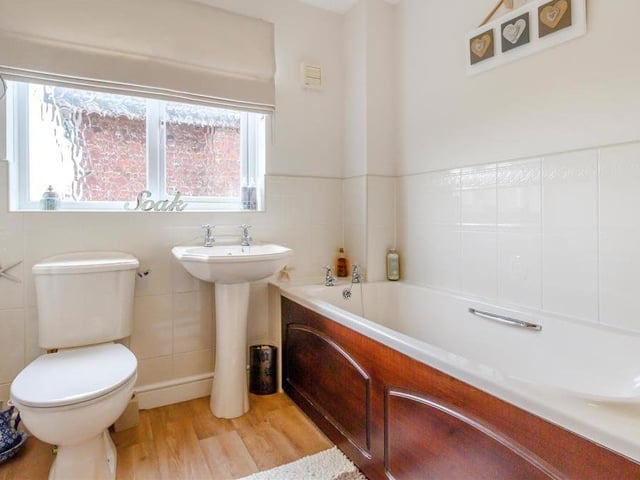 Before we leave the first floor, let's take a peek at the family bathroom. A four-piece suite comprises a panelled bath with tiled surround, a separate, tiled shower enclosure, a pedestal wash hand basin and a low-flush WC.