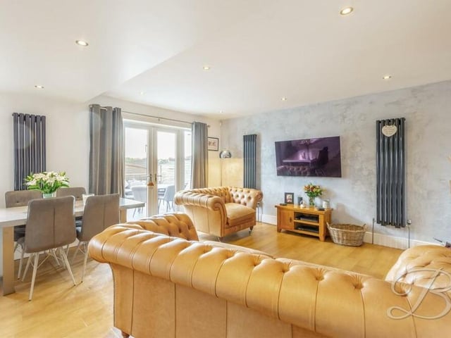 A third and final shot of the bright and comfortable living room/diner.