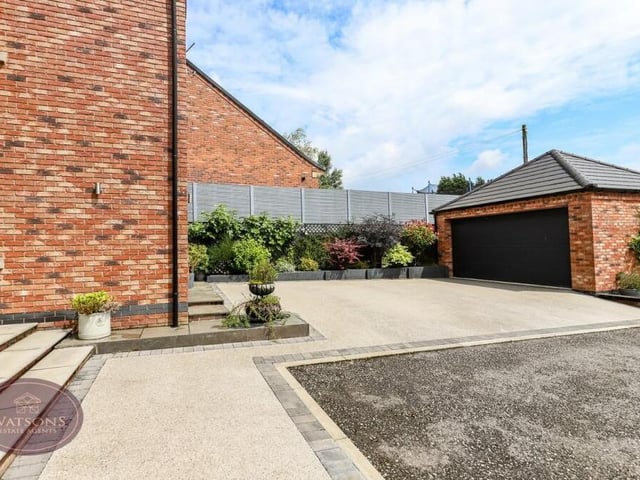 Returning to the front of the £700,000 Selston house, here is the substantial, detached double garage, which is fitted with power inside and out and an electric up-and-over door.  There is storage space available in its loft.