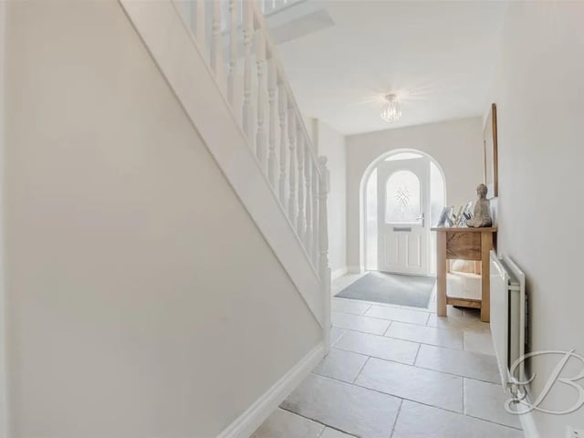 The welcoming and spacious entrance hall boasts a fitted storage cupboard located under the stairs