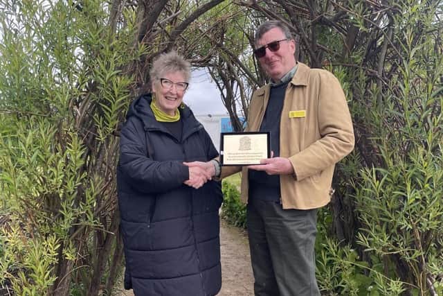 Jennie Street, of Rhubarb farm, receives award from Andrew Young of the National Garden Scheme