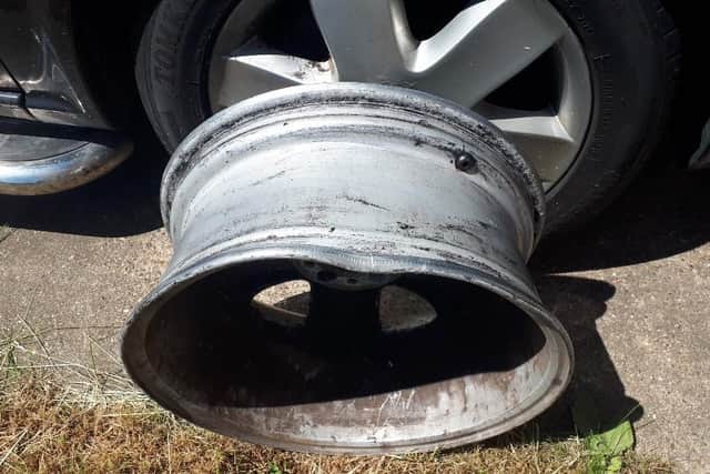 The damage to the wheel of the MPV car that was caused by the pothole accident.