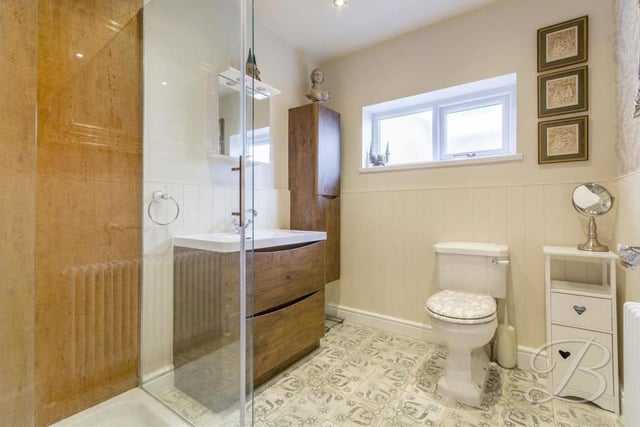 This modern shower room comprises a delightful three-piece suite. There is a walk-in shower cubicle, a low-flush WC, hand wash basin with storage, downlights and an opaque window to the side of the property.