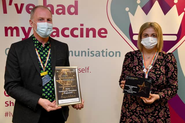 Kim pictured with CEO Paul Robinson, receiving a Staff Excellence Award on behalf of the vaccination team.