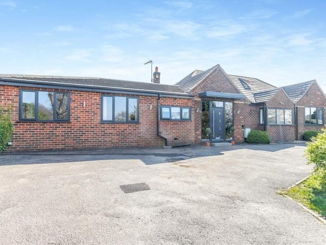 The front of the property, leading to the entrance. There is plenty of space for off-street parking.
