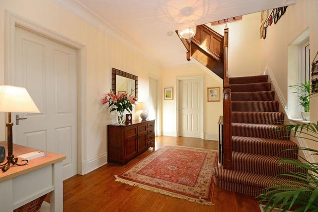 The reception hallway has an under-stair store and oak flooring.