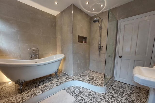 Before we take a look at the bedrooms, let's check out the wonderful family bathroom. It features a roll-top bath and a separate shower area.