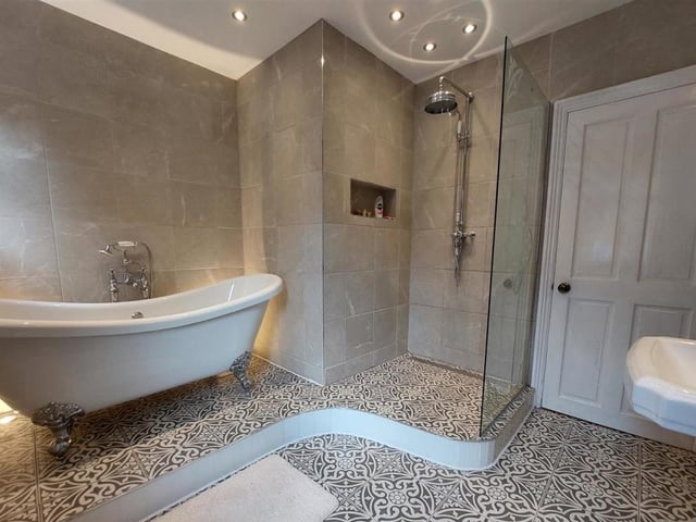 Before we take a look at the bedrooms, let's check out the wonderful family bathroom. It features a roll-top bath and a separate shower area.