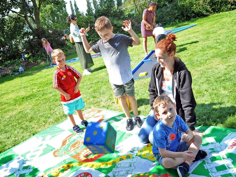 Amy Cawthorne with children, Ethan,10, Jacob, 6 and 5 year old Maggie enjoy the highs and lows of a giant snakes and ladders game at an Ashfield play forum fun day.