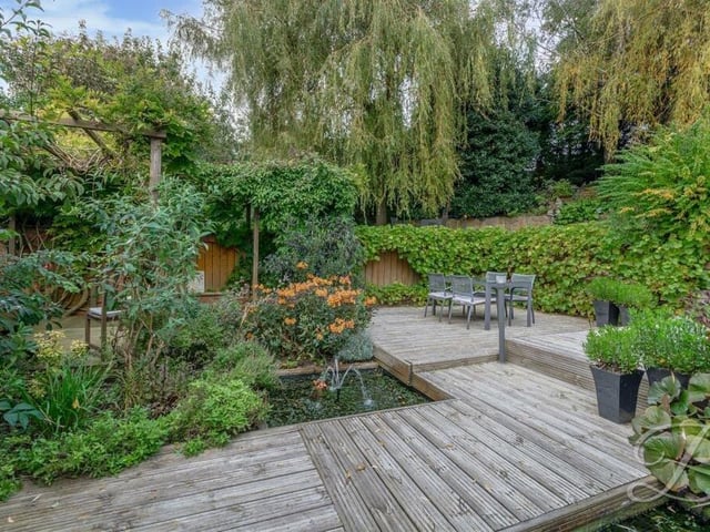 And finally, here's what you've been waiting for -- a few glimpses of the gorgeous garden at the Church Hill property. This decked seating area is surrounded by mature trees and decorative shrubbery.
