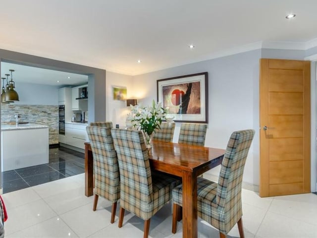A second look at the dining room, with its quartz-tiled floor, aluminium radiator, coving to the ceiling and six LED ceiling spotlights.