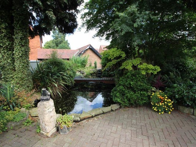 Here is our first view of the fish pond and water feature that add considerable character to the garden.