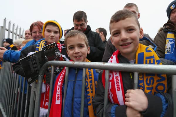 Fans await the arrival of the teams before the FA Cup Third Round match between Mansfield Town and Liverpool at One Call Stadium on January 6, 2013.