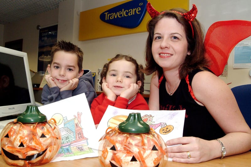 Sarah Slack centre staff member at Bulwell Travel Care presented Halloween prizes to the two winners of their Halloween drawing competition. At the time, left Charlie Mavin, aged 7 and Elissa Reeve, 5, both from Bulwell. Year: 2006