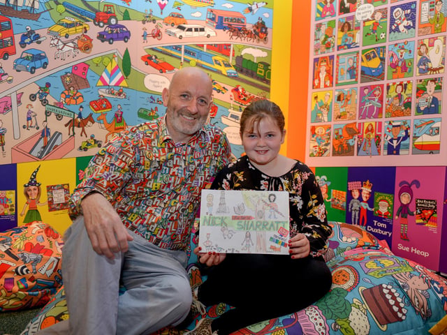 The Illustrated World of Nick Sharratt exhibition at Mansfield Library, pictured is superfan Suzy Phelan, 10 with author and illustrator Nick Sharratt in 2016.