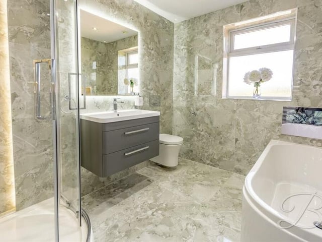 The family bathroom also includes a vanity hand wash basin, low-flush WC, floor-to-ceiling tiling and underfloor heating.