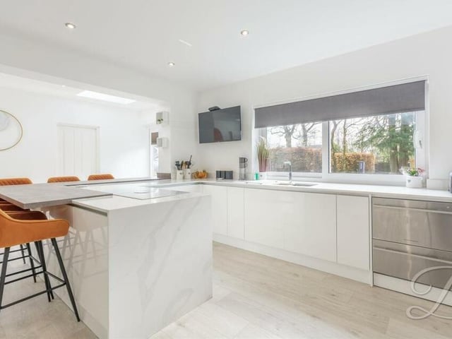 The kitchen features classy, gloss shaker-style cabinets, units and work surfaces with an inset sink that has a chrome mixer tap above. There is the perfect amount of space to showcase your culinary skills.