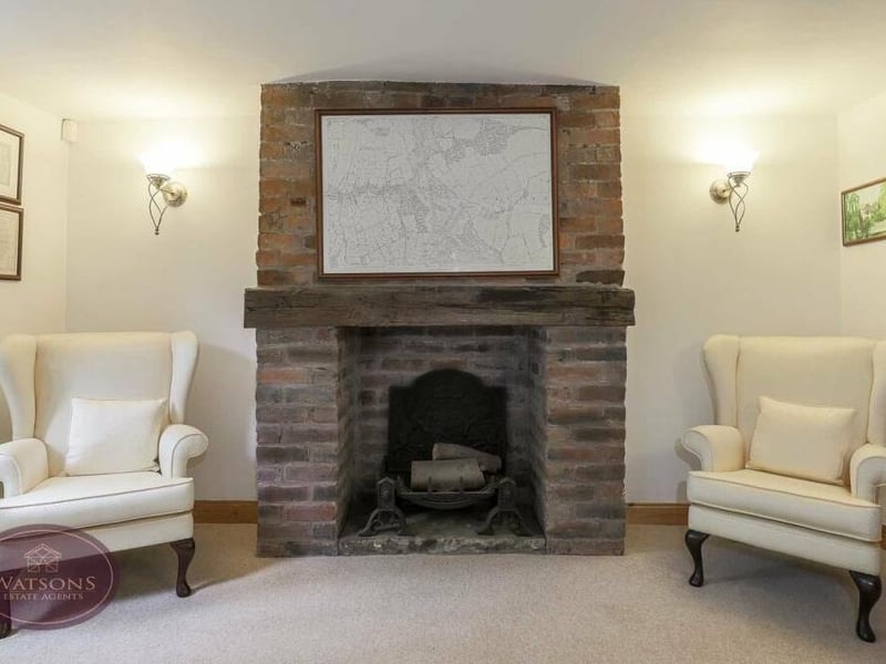A close up of the feature fireplace in the sitting room, which is an inglenook type,with inset space for a fire.