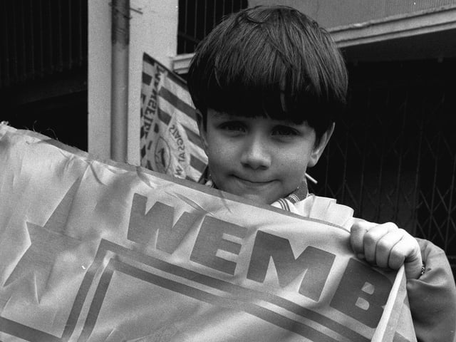 Holding his flag aloft - do you recognise this proud fan?