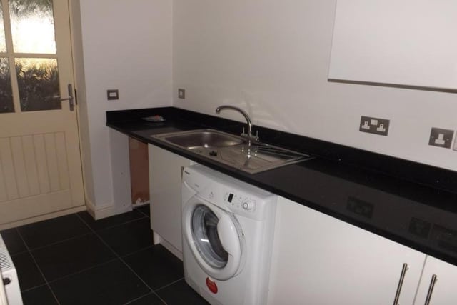 Not far from the kitchen is this handy laundry room. It has space and plumbing for a washing machine and tumble dryer.